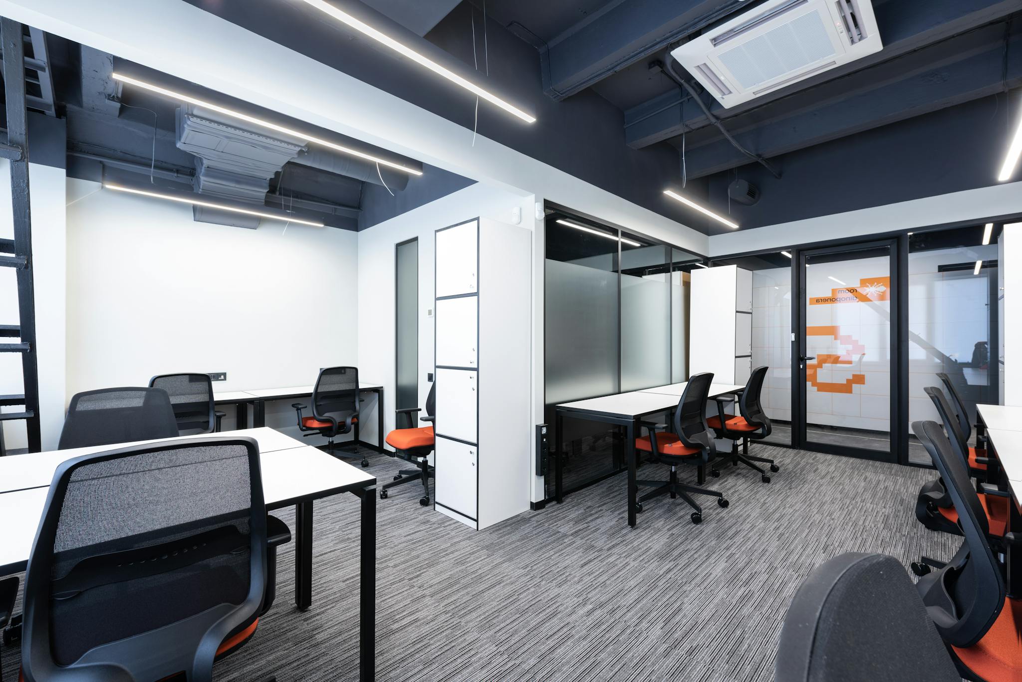 Photo by Max Vakhtbovycn - SITWELL Spacious and modern office interior with sleek furniture and bright lighting.