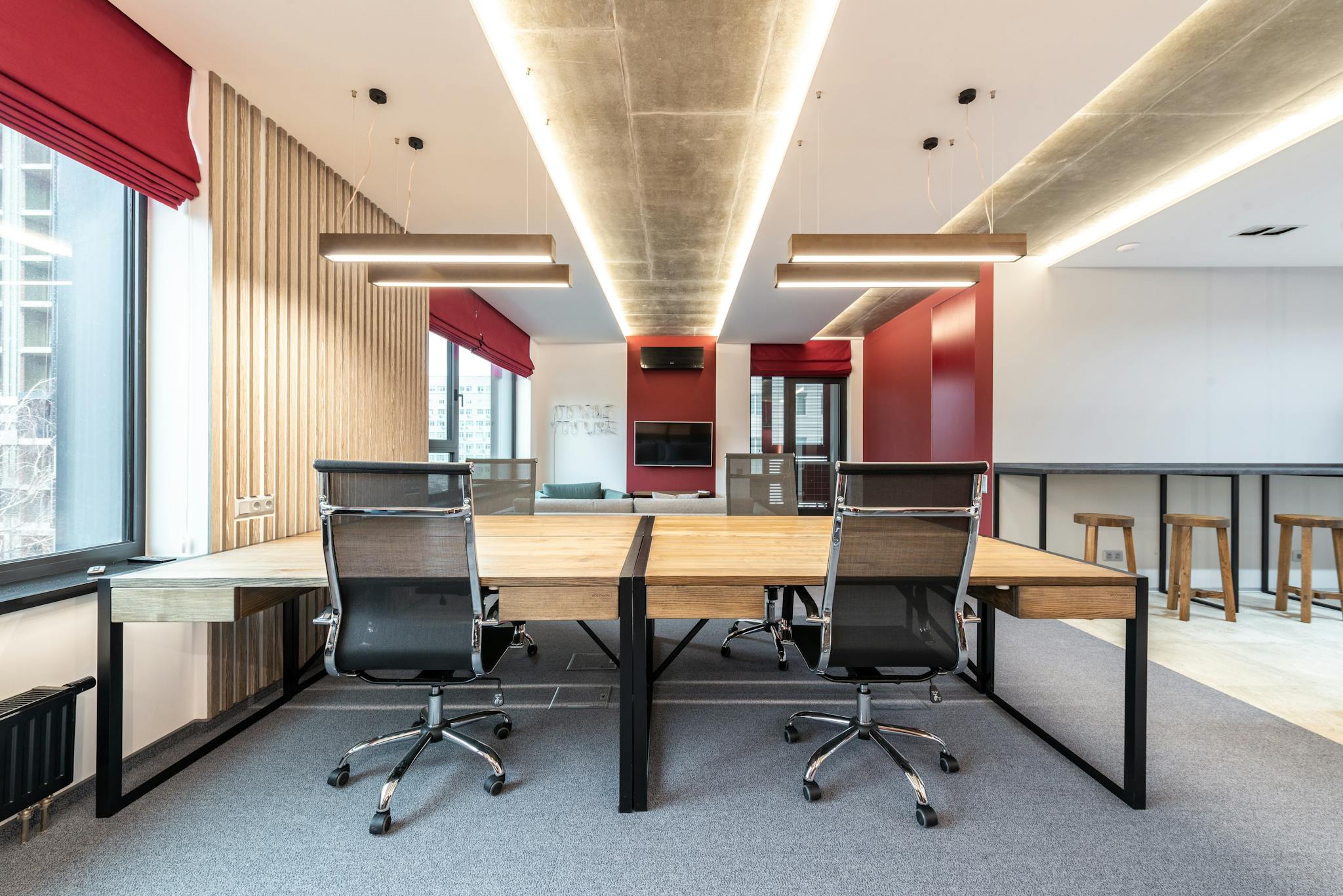 - SITWELL Spacious contemporary office with wooden desks and ergonomic chairs.